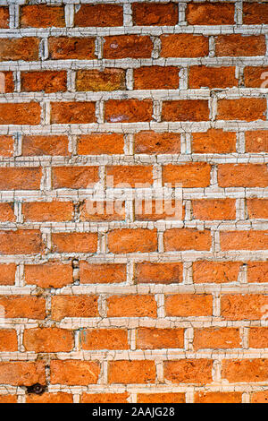 Texture background of red bricks wall, a continuous vertical brick  structure that encloses or divides an area of land. Stock Photo
