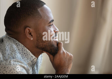 Close up of thoughtful biracial look in distance dreaming Stock Photo