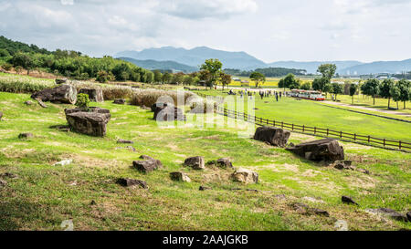 Several capstone dolmens scenery and tourists in the distance in Gochang dolmens site South Korea Stock Photo