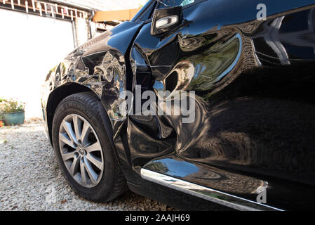 Car Crash: Damage and details of a wrecked vehicle. Close up crushed metal and plastic after a UK road traffic accident. Stock Photo