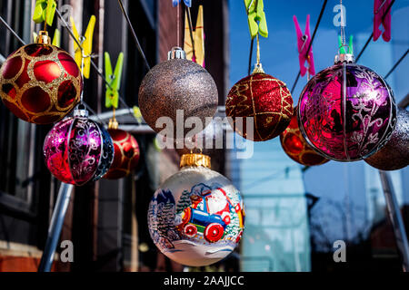Beautiful Christmas Balls Ornaments hanging on the clips on the  Clothes Drying Rack. Stock Photo