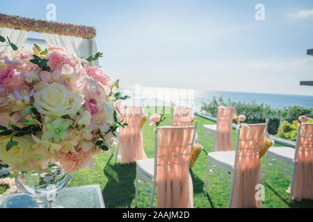 Flower decoration for Wedding ceremony in the day time with many chairs. vintage color tone Stock Photo