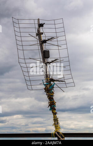 ugly old tv antenna outdoor on overcast sky background with selective focus Stock Photo