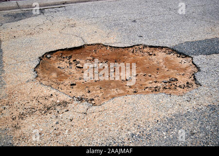 pothole in a florida tarmac road showing sandy substrate underneath florida usa Stock Photo