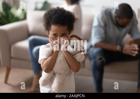 Focus on boy closed ears not to hear parents scandal Stock Photo