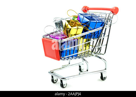 4 Wheel trolley shopping cart filled with variety color of gift boxes on isolated white background Stock Photo
