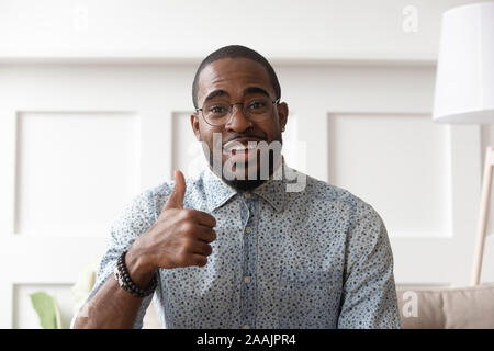 African man in glasses showing thumbs up looking at camera Stock Photo