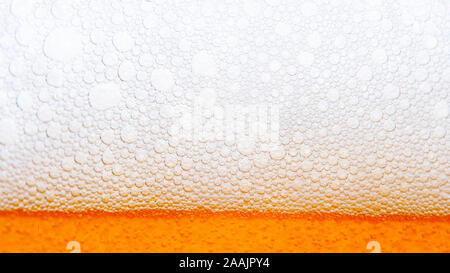 Dark Beer with Bubbles and Foam Background. Beer Bubbles Texture Closeup Stock Photo