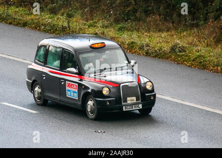 Black Cab 2018 London Taxis Int TX4 Bronze Auto;  London Taxi UK Vehicular traffic, transport, modern vehicles, saloon cars, south-bound motoring on the 3 lane M6 motorway highway. Stock Photo