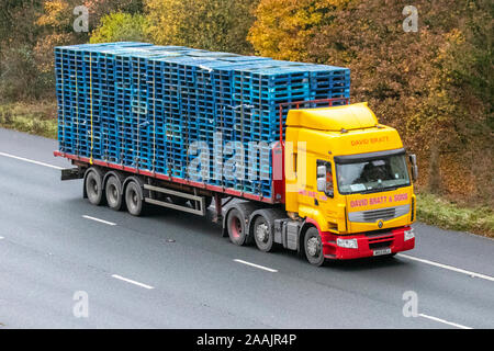 David Bratt & Sons Haulage delivery trucks carrying blue wooden pallets; , lorry, transportation, truck, cargo carrier, Renault vehicle, commercial transport, industry, M61 at Manchester, UK Stock Photo