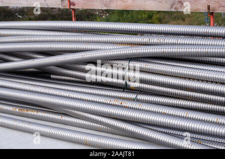 Metal pipes in a stack on a construction site Stock Photo