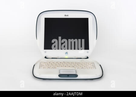 Los Angeles, California, USA - November 6, 2019:  Illustrative editorial photo of old Apple clamshell style iBook laptop computer on white.  This mach Stock Photo