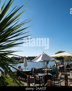 Riverside Pub scene, alongside The Norfolk Broads National Park, at Horning, on the River Bure, Horning, Norfolk, England, UK Stock Photo