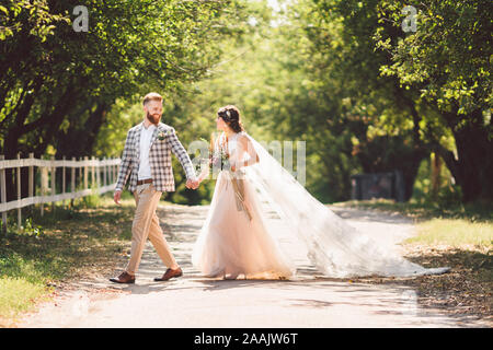 https://l450v.alamy.com/450v/2aajw6t/lovely-wedding-couple-wood-forest-bride-and-groom-follow-me-married-couple-woman-in-white-wedding-dress-and-veil-rustic-outdoors-love-story-2aajw6t.jpg