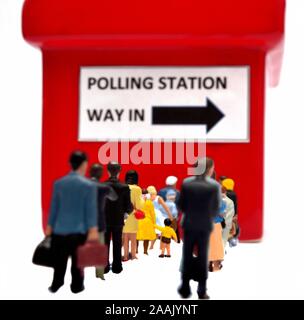 Miniature figurines queuing in front of a polling station UK Stock Photo