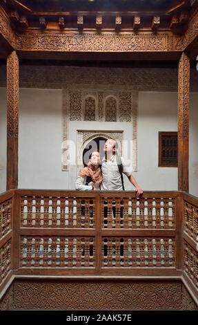 Young couple in the beautifully restored Ben Youssef Medersa. It is the largest theological school in Morocco. Marrakech Stock Photo