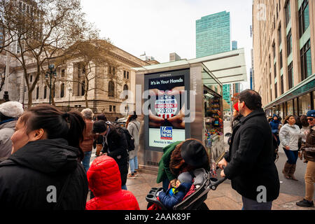 Pedestrians wait to cross 42nd Street in New York in front of an digital display advertising Fox News’ coverage of the 2020 U.S. election, seen on Sunday, November 17, 2019 (© Richard B. Levine) Stock Photo