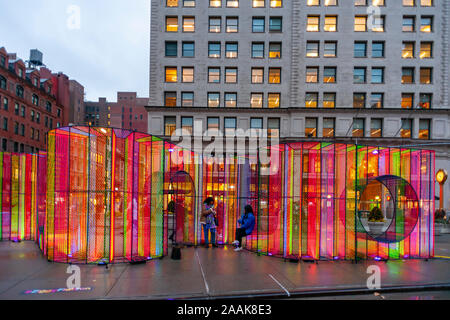 Visitors to Flatiron Plaza in New York on Monday, November 18, 2019 interact with ÒZiggyÓ created by Hou de Sousa. The Christmas installation is the centerpiece of the Flatiron/23rd Street Partnership's holiday programming, Ò23 Days of Flatiron CheerÓ. ÒZiggyÓ contains 27,000 feet of iridescent cord illuminated by uv lighting. (© Richard B. Levine) Stock Photo