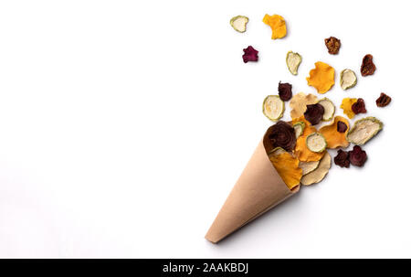 Crisp crunchy organic vegetable chips in paper cup. Oven-baked pumpkin, beetroot, squash, tomato, carrot chips snacks Stock Photo