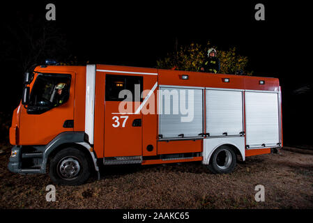 Fire brigade during operation in the field at night time Stock Photo