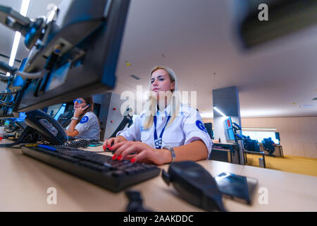 Female security operator working in a security  data control room offices Stock Photo