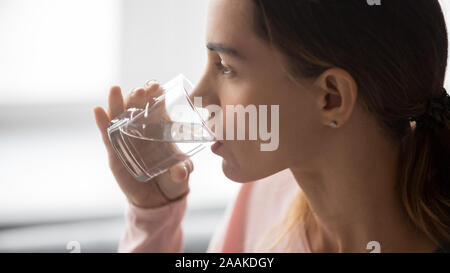 Close up of thirsty girl enjoying pure mineral water Stock Photo