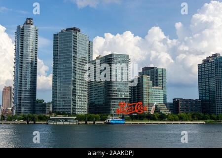 New York, USA - August 20, 2018: Long Island City waterfront with landmark Pepsi Cola sign located at Gantry Plaza State Park in Queens Stock Photo