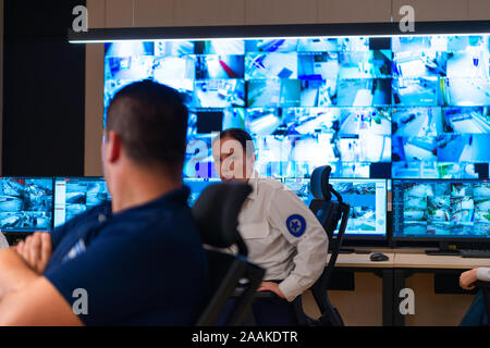 Team of secret agents in uniforms, monitoring cyber, video and communications at the main control data center station. Stock Photo