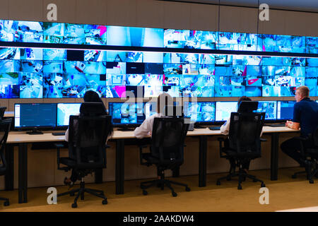 Team of secret agents in uniforms, monitoring cyber, video and communications at the main control data center station. Stock Photo