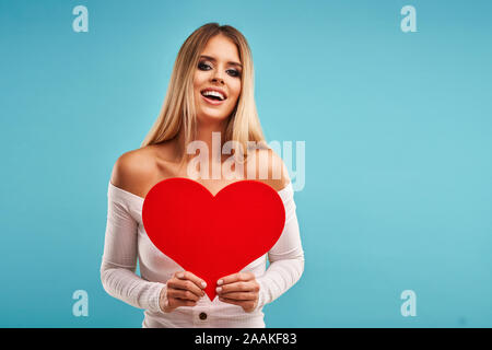 Beautiful adult woman posing over blue background Stock Photo