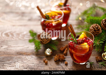 Christmas mulled wine. Traditional festive drink with decorations and fir tree Stock Photo