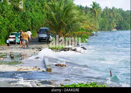 Tuvaluans watch helplessly as the high tide inundates their island home on Funafuti, washing from one side of the island to the other. Stock Photo