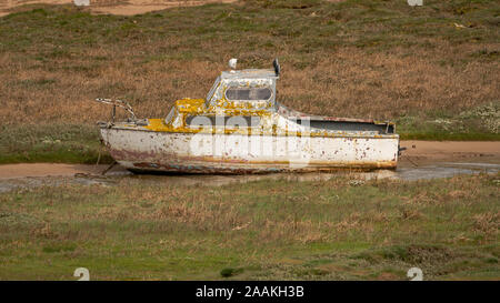 The wreck of a boat in the grass, seen in Askam-in-Furness, Cumbria, England, UK Stock Photo