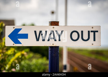 Sign: Way Out, with blurry background, seen in Kirkby-in-Furness, Cumbria, England, UK Stock Photo