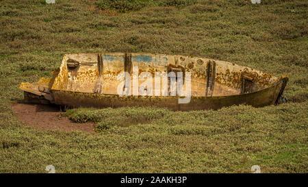 The wreck of a boat in the grass, seen in Askam-in-Furness, Cumbria, England, UK Stock Photo