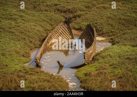 The wreck of a boat in the grass, seen in Askam-in-Furness, Cumbria, England, UK Stock Photo