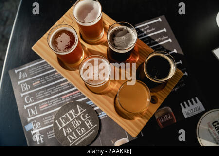 A Flight of beers selection at Letraria Craft Beer Garden in Porto Portugal. Stock Photo