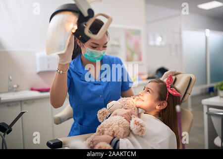 Little child at stomatology. Happy Girl with dentist. Health teeth concept. Stock Photo