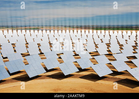 Heliostats, large reflective mirrors directing sunlight to the PS20 solar thermal tower. Stock Photo