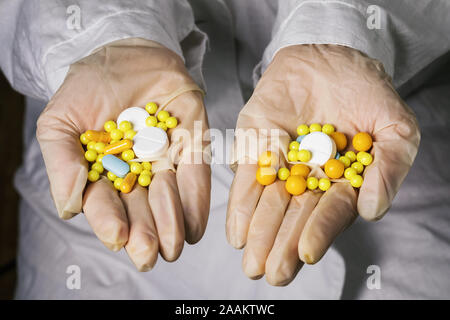 Various pills in the hands of a doctor closeup. Drug production concept Stock Photo