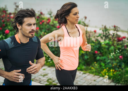 Exercising by the river with personal trainer. Stock Photo