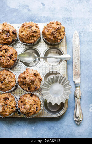 Freshly baked chocolate chip muffins on baking pan Stock Photo