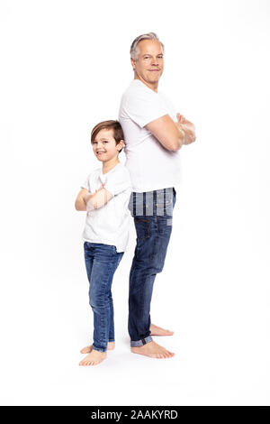 Father and son with arms crossed, white background Stock Photo