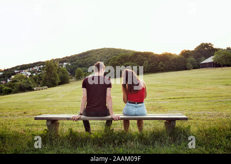 Couple sitting on bench overlooking hills, Wilhelminenberg, Vienna, Austria Stock Photo