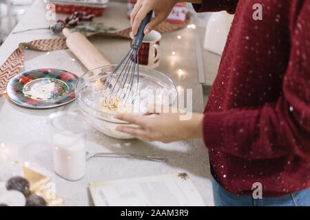 Girl preparing Christmas cookies dough on kitchen bar Stock Photo