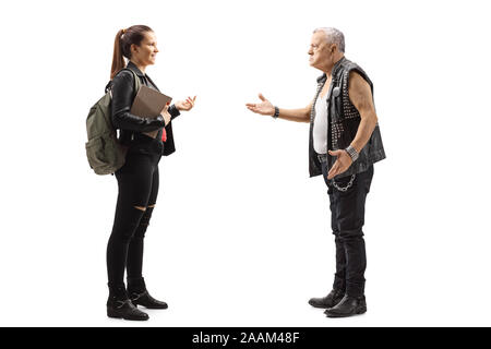 Full length profile shot of an angry mature punk talking to a young female student isolated on white background Stock Photo