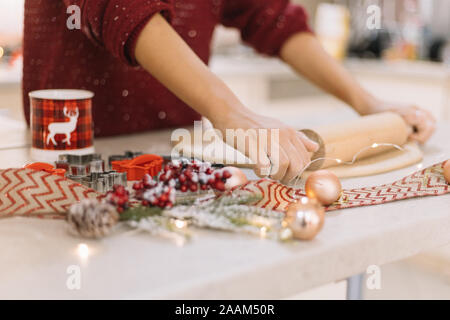 Side view of womans hands rolling cookie dough Stock Photo