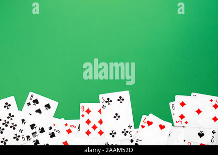 Deck of playing cards on green background copy space Stock Photo