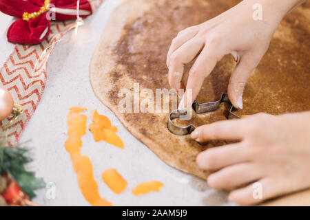 Girl making man shaped cookies for Christmas Stock Photo