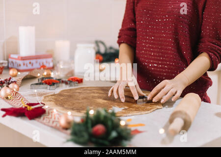Christmas tree-shaped metal cutter on gingerbread dough Stock Photo